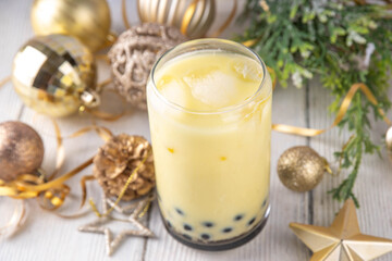 Christmas holiday eggnog boba milk tea cocktail. Trendy eggnog bubble tea or latte with New year and Xmas decorated background, copy space