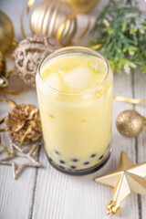 Christmas holiday eggnog boba milk tea cocktail. Trendy eggnog bubble tea or latte with New year and Xmas decorated background, copy space