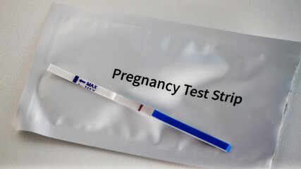 A pregnancy test strip is shown on a white background