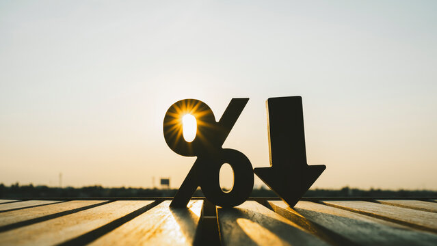 Percentage model and down arrow with evening sky. Key concepts for success, methods, systems of raising or lowering Fed interest rates to correct inflation concepts.