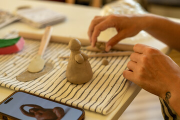 Handcrafting a Clay Sculpture of a Woman During Pottery Workshop