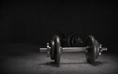 Two dumbbells on dark background with copy space. 