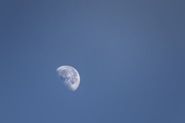 Moon on blue morning sky, minimalistic view for background