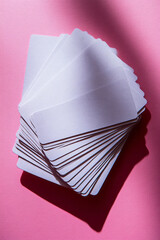 A stack of flashcards fanned out on a pastel pink background, ready for a quick study session,
