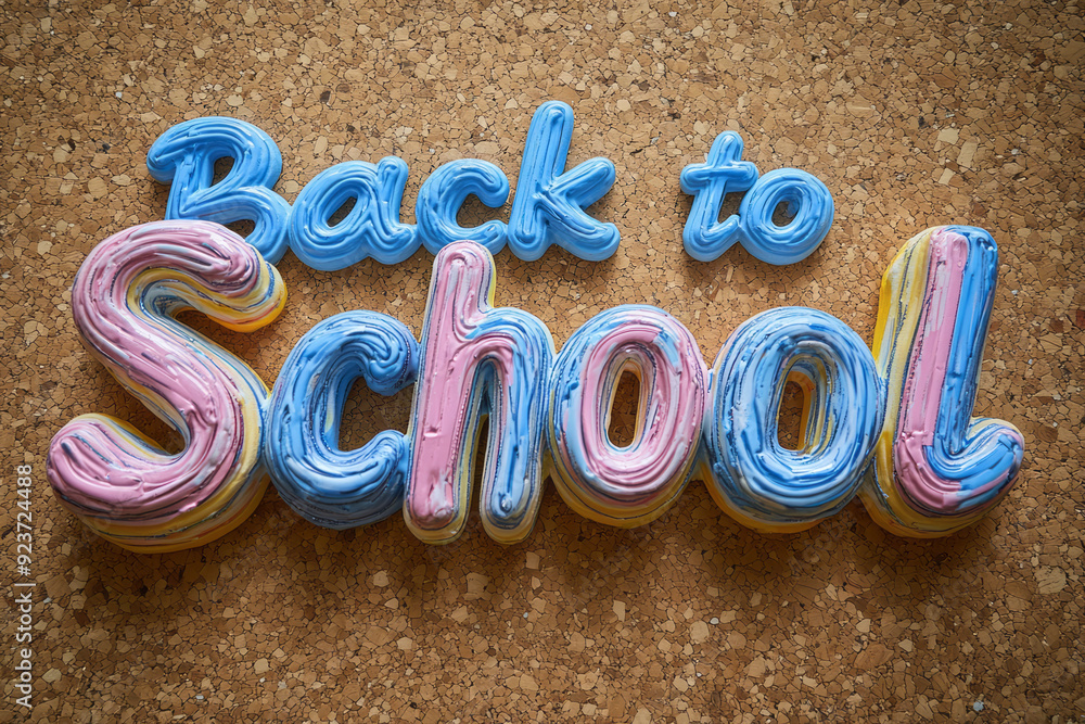 Poster the words back to school created using lined notebook paper cut into letters, isolated on a corkboar
