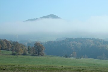 fog covers the mountains in the background