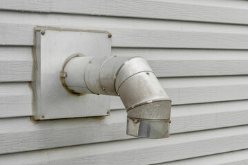 Laundry dryer vent pipe on house exterior