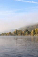 Fototapeta premium the fog reveals the hill on the river