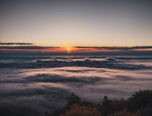 A Beautiful Sunrise Over a Sea of Clouds Seen From a Mountain Peak