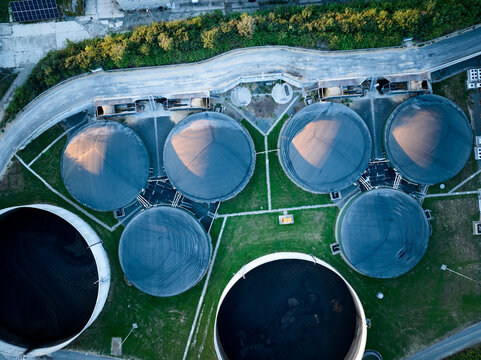 Vertical view of the process components, fermenters and biogas storage tanks of the agricultural biogas plant. Use of biogas in cogeneration units for electricity and heat production.