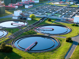 Aerial view of wastewater treatment plant with aeration tanks and clarifiers, ideal for...