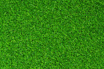 Artificial green grass mat, top view. Texture. Artificial turf, surface made of synthetic fibers....