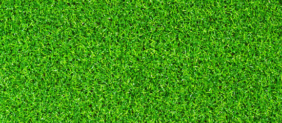 Fototapeta premium Artificial green grass mat, top view. Texture. Artificial turf, surface made of synthetic fibers. Flat green grass texture background. Short artificial grass golf surface