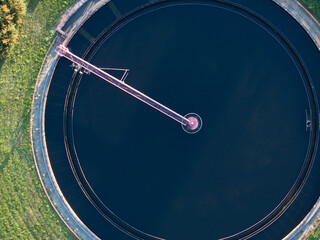 Aerial view of modern wastewater treatment plant with storage tanks in sunset. Ideal for wastewater management theme.