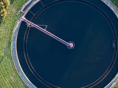 Aerial view of modern wastewater treatment plant with storage tanks in sunset. Ideal for wastewater management theme.