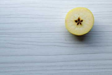 Close-up of a sliced apple on a wooden table