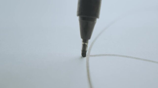 Close-up view of a pencil drawing on white paper in slow-motion