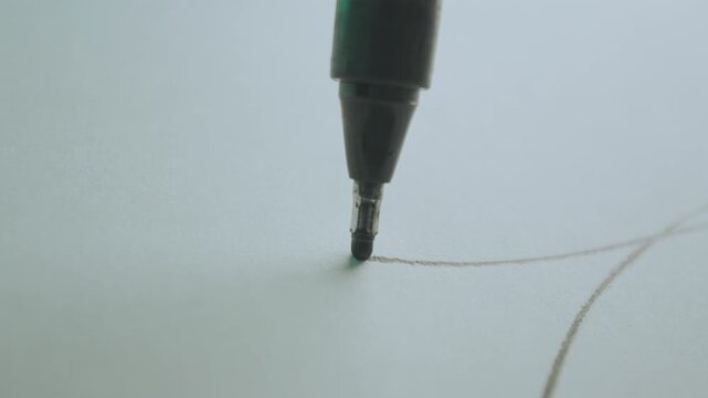 Macro Slider shot across a fresh piece of white paper as someone drawing a lines on architectural blueprint paper with a pencil