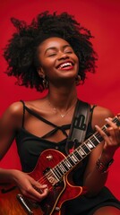 Obraz premium A joyful woman is playing her electric guitar, smiling against a bright red backdrop