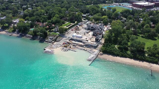 Phoenix Suns co-owner Justin Ishbia builds a 68,000 sq. ft. home for $44 million along the shores of Lake Michigan in Winnetka, IL amid controversy regarding beach access and a land swap.