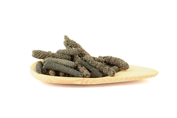Indonesian spice Long Pepper or Pippali on a wooden serving plate.