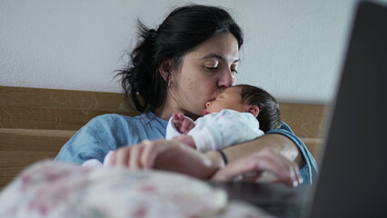 Woman multitasking with a laptop and newborn baby in a cozy bedroom setting, exemplifying the balance between work and parenting, modern family dynamics, and nurturing maternal love