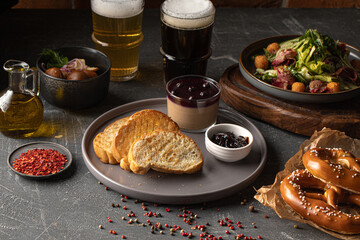Portion of chicken liver pate with currant jam and toasts