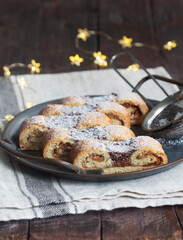 Grandfather's mustache cookies made from shortcrust pastry filled with nuts, jam and cocoa, Christmas toys and garland.