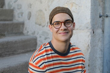 Young guy wearing eyeglasses and a hat 