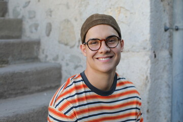 Young guy wearing eyeglasses and a hat 