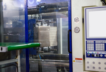 Process of plastic buckets on plastic injection molding press machine. Manufacturing factory