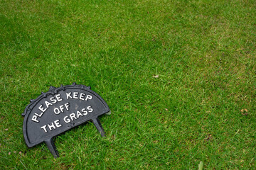 Please keep off the grass sign fallen down