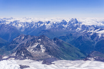 Naklejka premium landscape of the high mountains above the clouds from the snowfield on the slope of Mount Elbrus