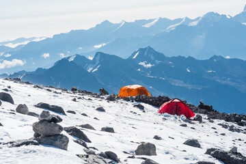 high mountain landscape with tents, mountaineering camp among eternal snows and rocks