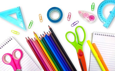 Top view of a variety of school supplies arranged neatly on a white background, showcasing the back-to-school theme.