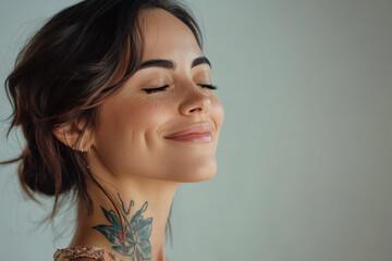 Fototapeta premium A close up of a woman's face with tattoos and her eyes closed