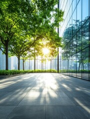 Modern glass building with sunlit trees and cityscape reflecting on windows, creating a harmonious blend of nature and urban architecture.