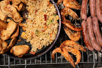 Grillin up a feast chicken shrimp sausages and fried rice Summer vibes
