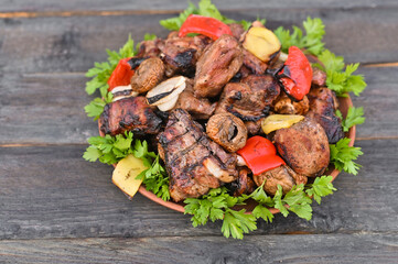 Shish kebab of meat and vegetables in a plate.