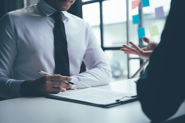 The Interview: A close-up perspective of a job interview, capturing the focused attention and nervous energy of a candidate being interviewed. The image evokes the anticipation, pressure, and possibil