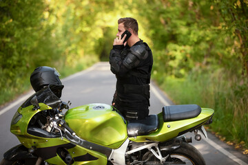 motorcyclist near green sports bike