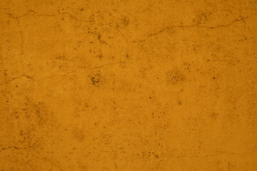 A close up of a textured yellow wall The cracks and imperfections give the wall character