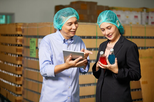 businessman and businesswoman checking basil seed drink or product in the beverage factory