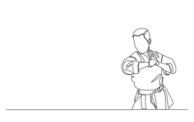 One continuous line drawing karateka fighter in kimono practicing karate kick combat. Karateka sport single line illustration.