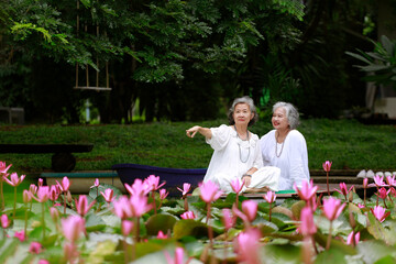 Senior Women Enjoying Lotus Pond and Nature View
