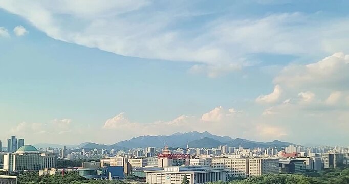 cloudscape with a cityscape of Yeouido, Seoul, Korea, a timelapse of a beautiful blue sky with white clouds during sunset, for the background	