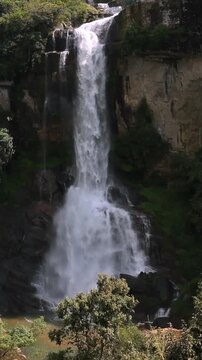 A huge waterfall in the jungle with sound. Ramboda Falls in Sri Lanka.