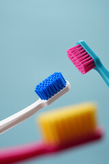Advertising of oral hygiene. Three toothbrushes on a blue background close-up.