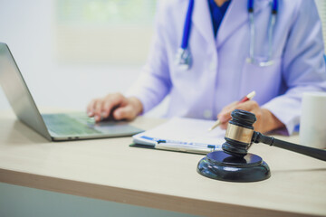 The hammer of justice is a law protecting doctors in diagnosing patients and leading to their death. Hospital insurance considers safety in judgment with lawyers, judges, courts, copy space.