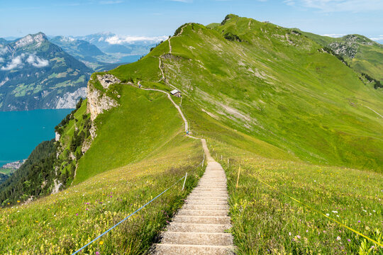 Steep trail of stairs on the Stoos Ridge hike in Switzerland, with Lake Lucerne in the background